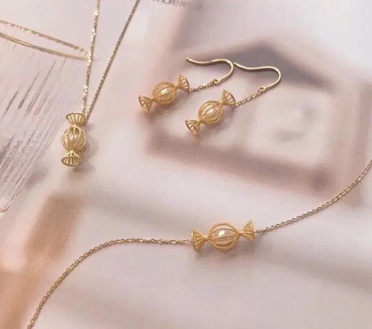 Delicate gold candy-shaped necklace and earrings set, perfect for Sydney jewellery lovers seeking elegant, romantic designs.
