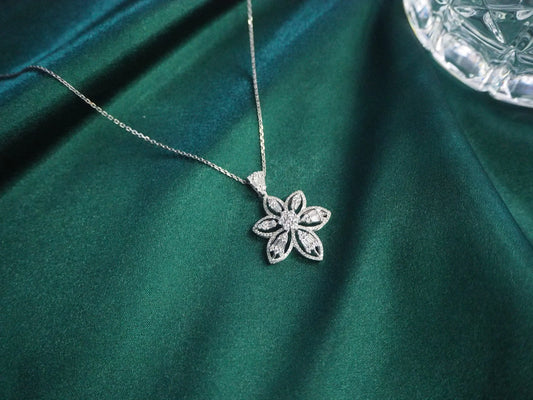 Elegant flower pendant necklace with sparkling stones on green velvet, perfect for Sydney jewellery lovers.