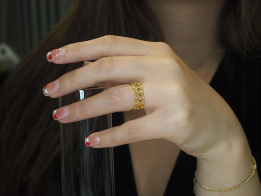 Elegant gold ring with emerald and diamond accents on woman's hand, showcasing Sydney jewellery style