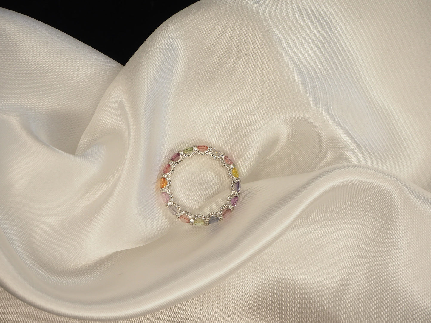Elegant multi-color gemstone ring on satin fabric, perfect for Sydney jewellery lovers