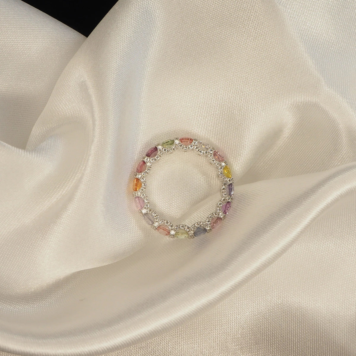 Elegant multi-color gemstone ring on satin fabric, perfect for Sydney jewellery lovers