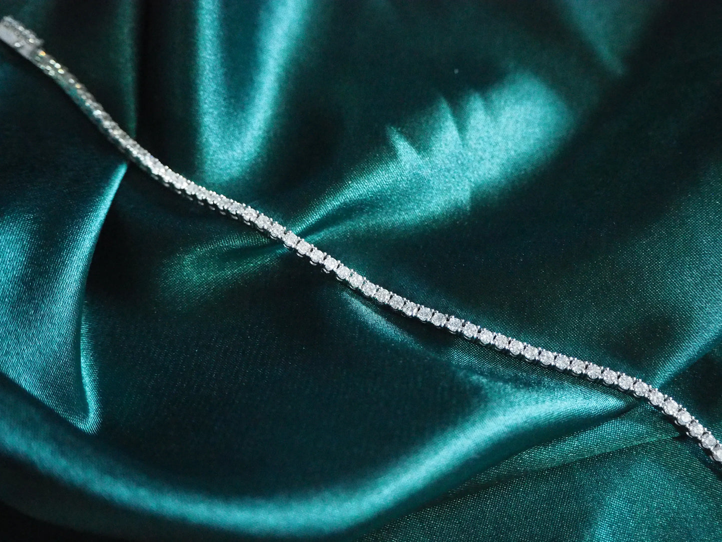 Elegant diamond tennis necklace on teal satin, perfect for luxury Sydney jewellery lovers