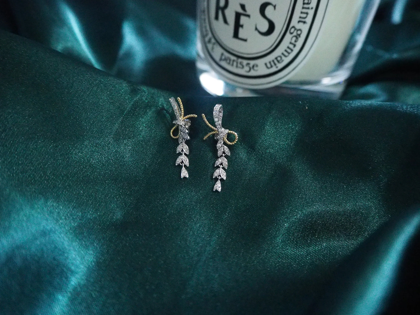 Elegant leaf-design drop earrings with diamond accents on dark green satin, perfect for Sydney jewellery lovers