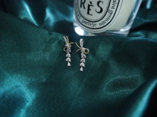 Elegant leaf-design drop earrings with diamond accents on dark green satin, perfect for Sydney jewellery lovers