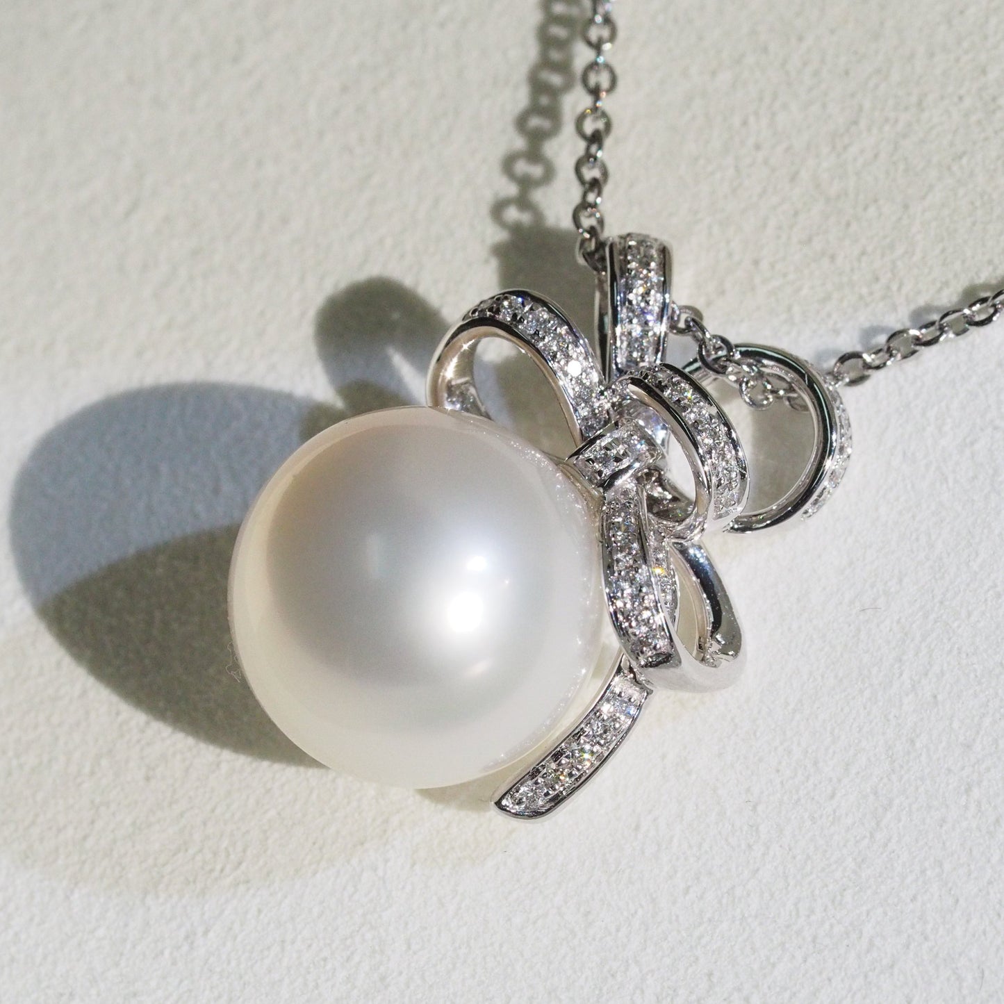 Diamond bow South Sea pearl pendant close-up — AAA lustre 18K white gold | Tayam Jewellery Sydney