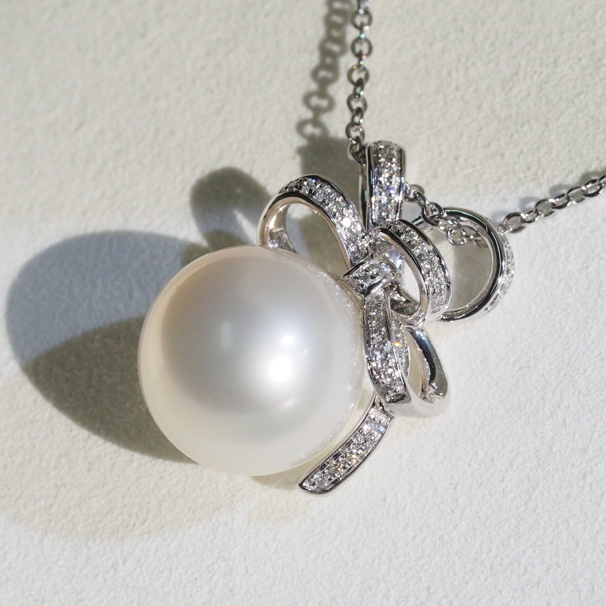 Diamond bow South Sea pearl pendant close-up — AAA lustre 18K white gold | Tayam Jewellery Sydney