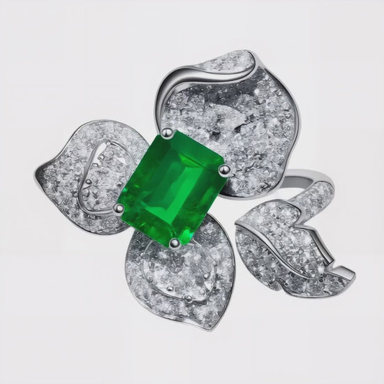 High-resolution video of 1.58ct emerald center stone ring with diamond flower petals set in 18K white gold, luxury jewellery crafted in Sydney.
