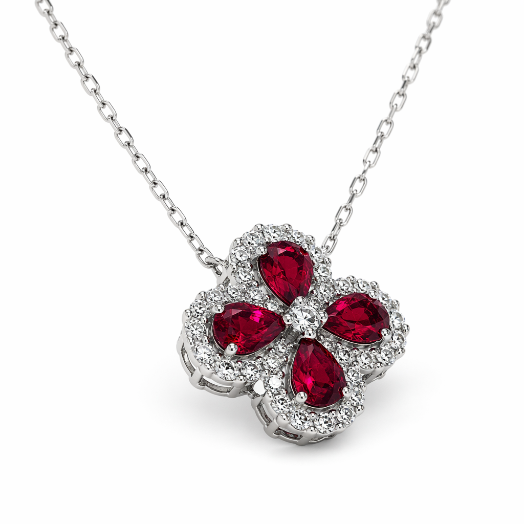 Ruby diamond four-leaf clover pendant close-up showing pear-cut rubies and diamond halo