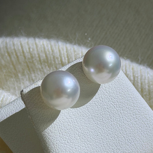 Untreated South Sea pearl earrings close-up — perfectly round 9-10mm natural white pearl Sydney