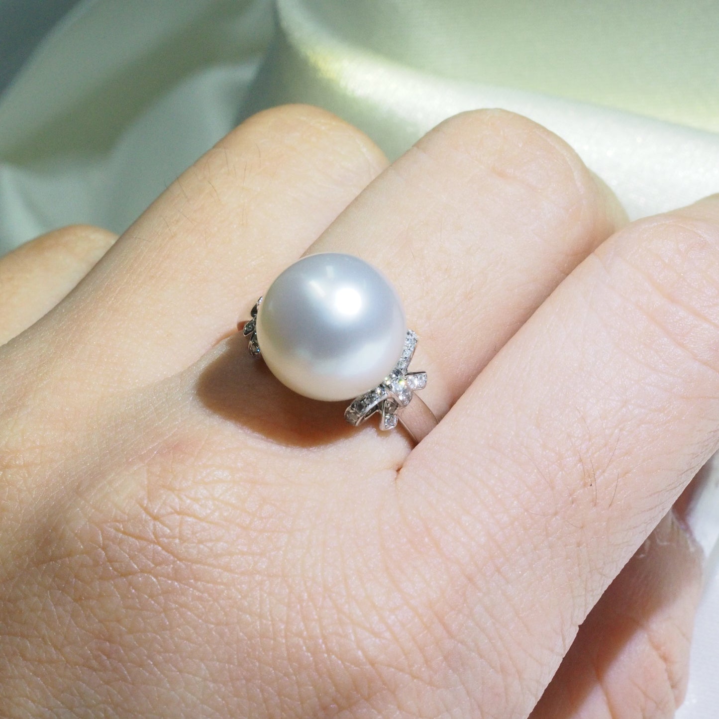 Australian South Sea pearl ring worn on hand — 18K white gold diamond bow design Sydney CBD