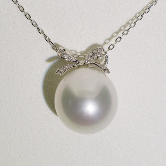 Diamond bow pearl pendant close-up — platinum AAA lustre | Tayam Jewellery Sydney