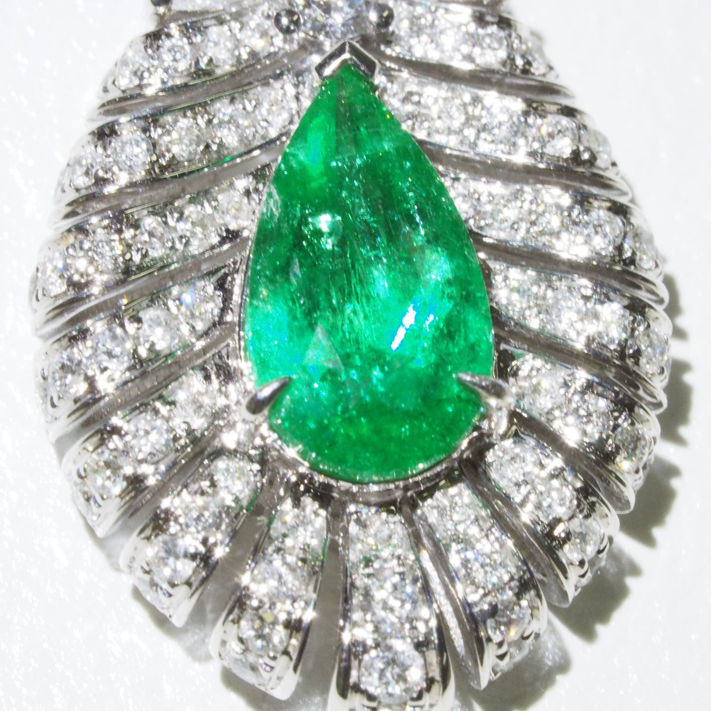 Zambian emerald feather pendant close-up — pear cut emerald with diamond-set quills | Tayam Sydney