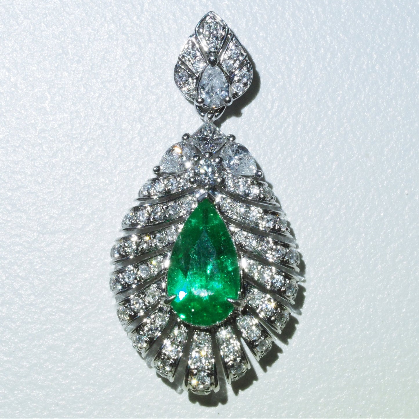0.63ct emerald feather pendant side view — sculptural pavé diamond setting 18K white gold | Tayam Sydney CBD