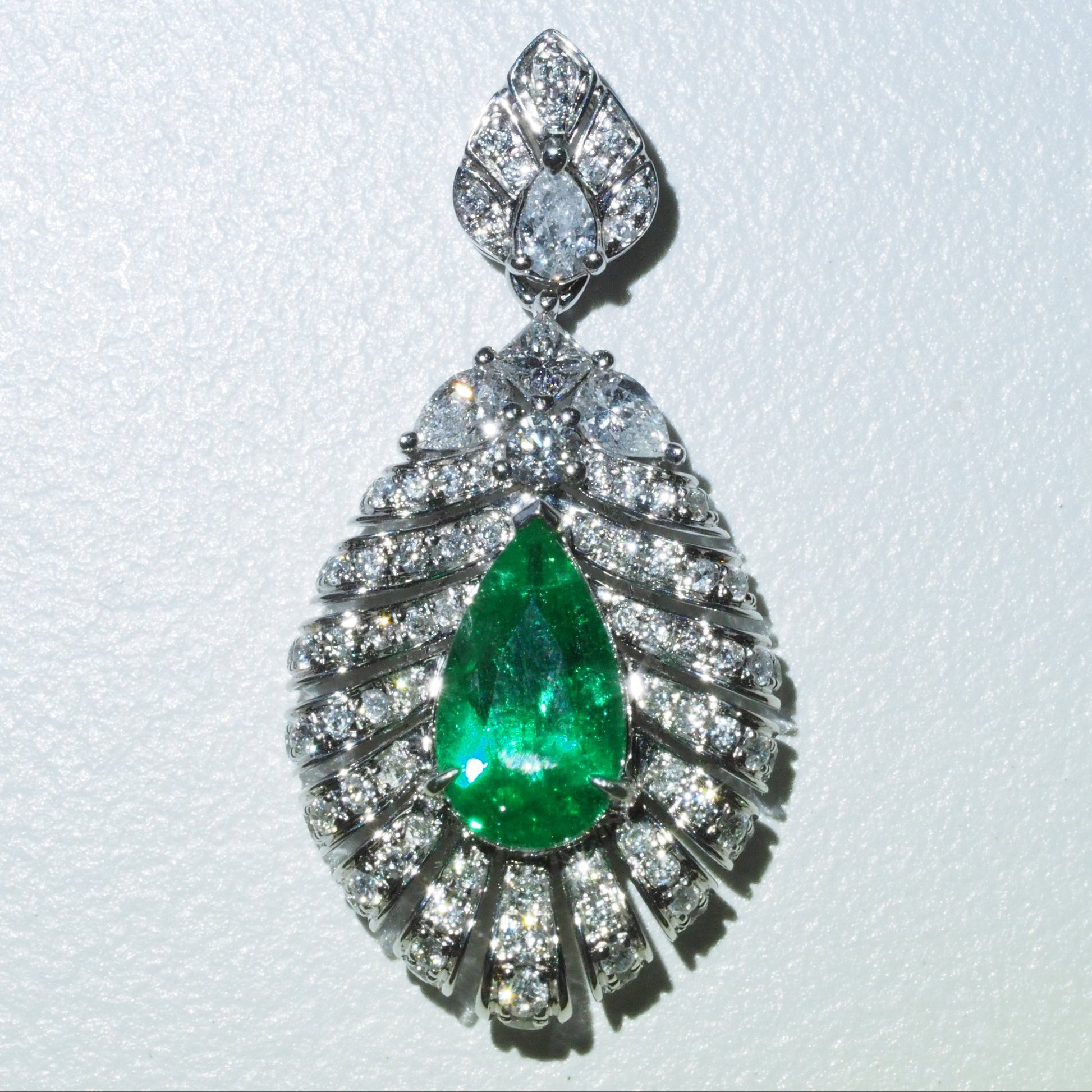 0.63ct emerald feather pendant side view — sculptural pavé diamond setting 18K white gold | Tayam Sydney CBD