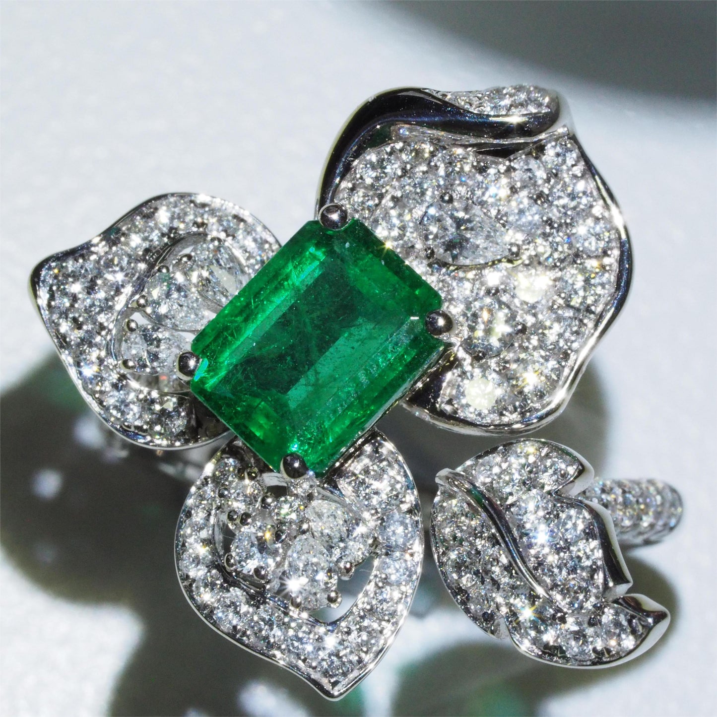 1.58ct emerald flower ring side profile — diamond-set band in 18K white gold | Tayam Jewellery Sydney CBD