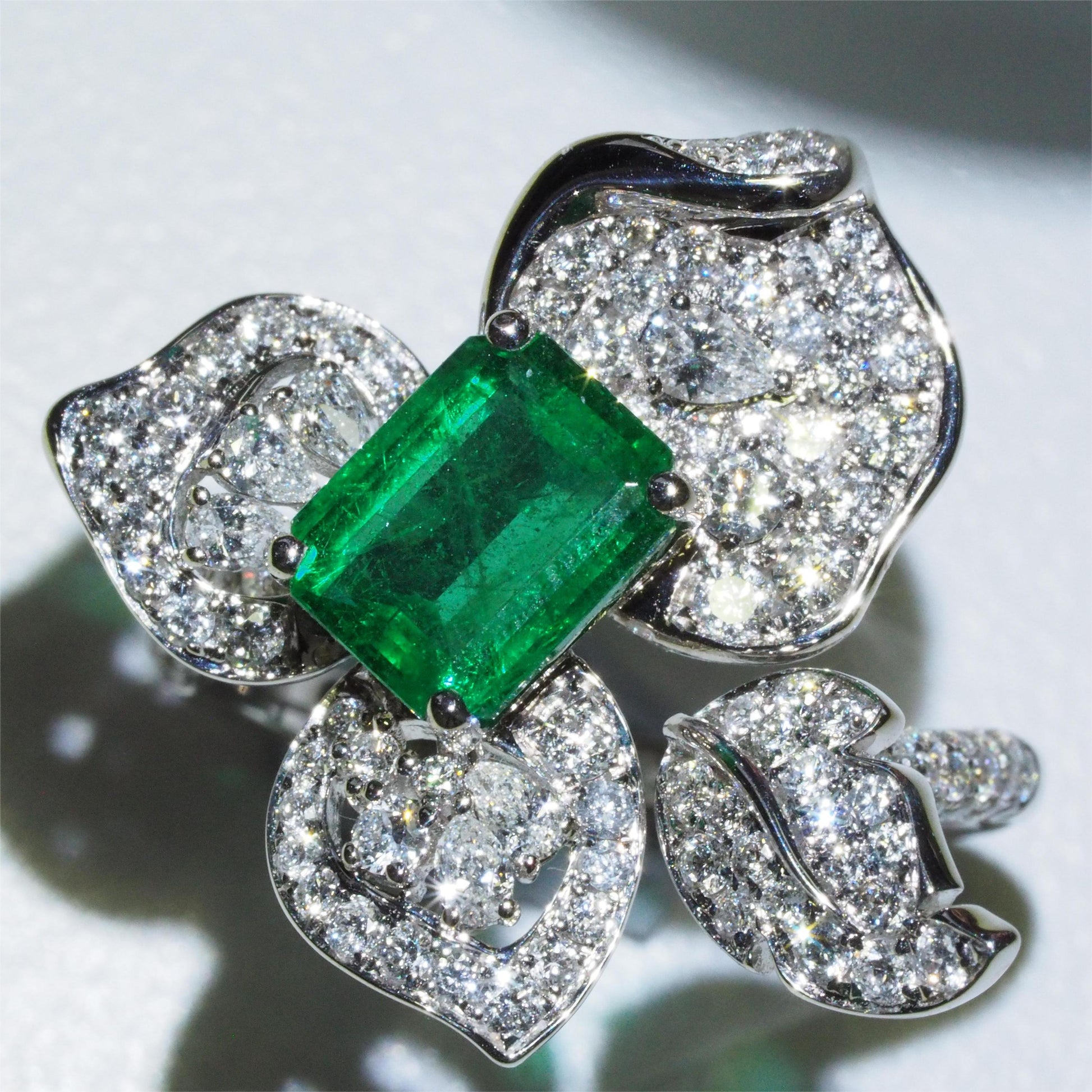 1.58ct emerald flower ring side profile — diamond-set band in 18K white gold | Tayam Jewellery Sydney CBD