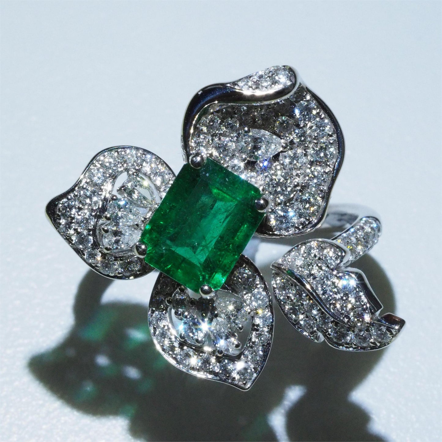 Zambian emerald flower ring top view — pavé diamond petals with pear and round cut diamonds | Tayam Sydney