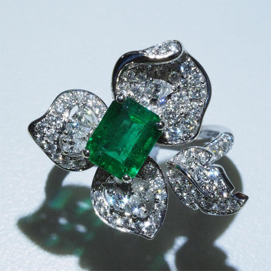 Zambian emerald flower ring top view — pavé diamond petals with pear and round cut diamonds | Tayam Sydney