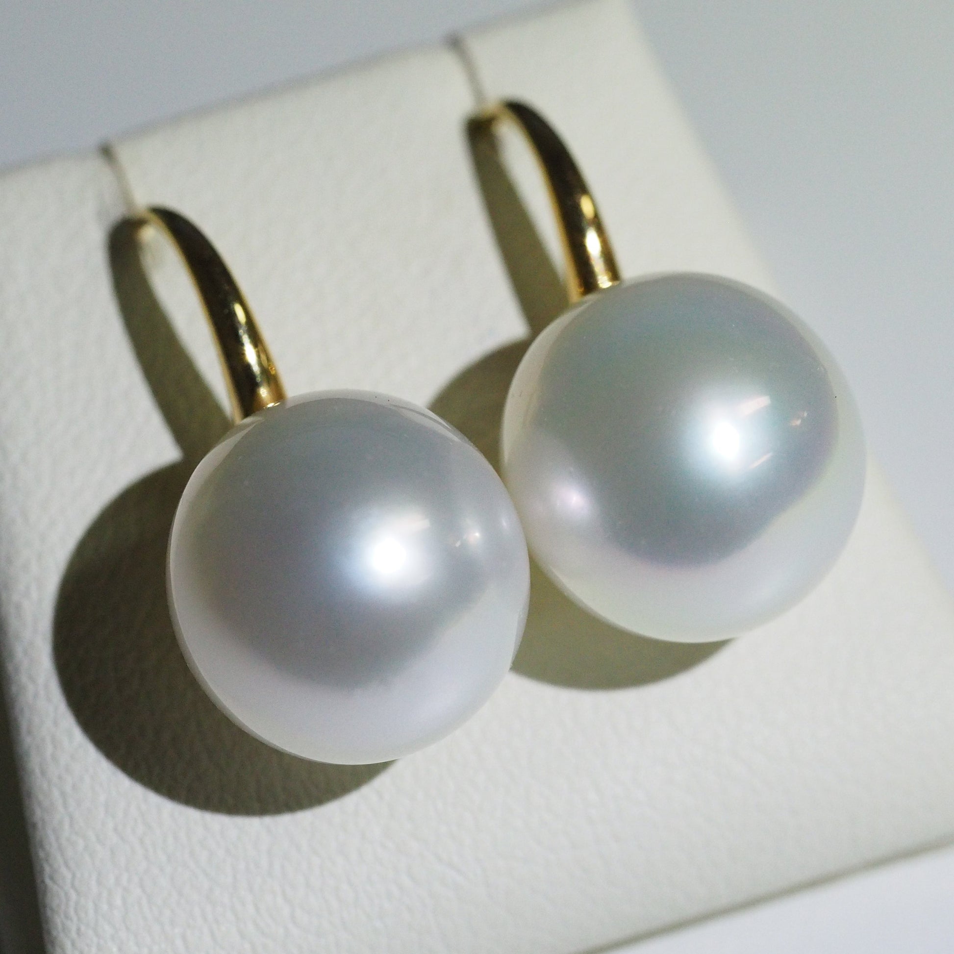 South Sea pearl earrings close-up — pink green overtones AAA lustre 18K yellow gold | Tayam Jewellery Sydney