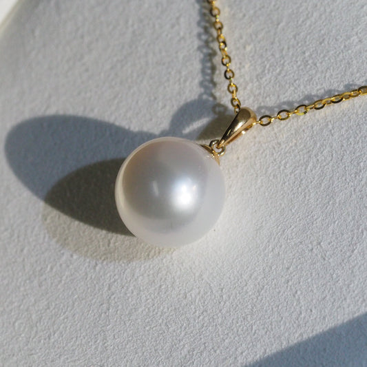 South Sea pearl pendant close-up — round pearl pink overtones 18K yellow gold | Tayam Jewellery Sydney