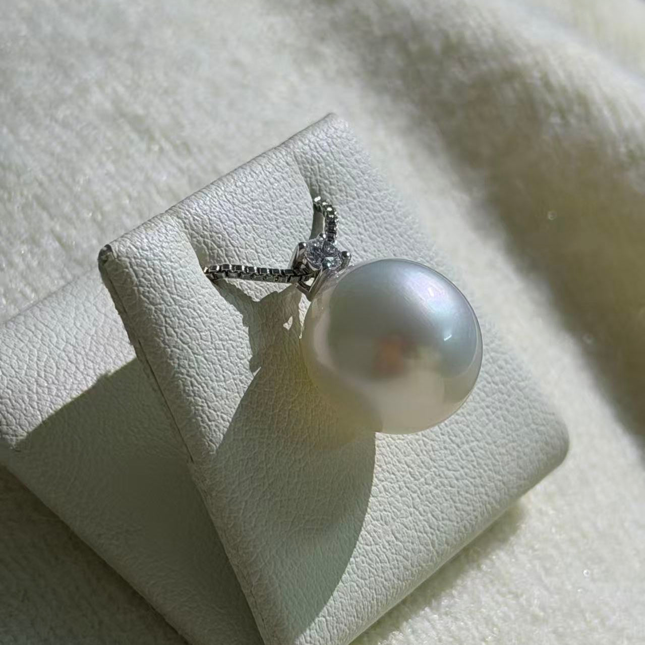 Australian pearl pendant side angle — natural 12mm oval South Sea pearl lab diamond 9K gold Sydney CBD