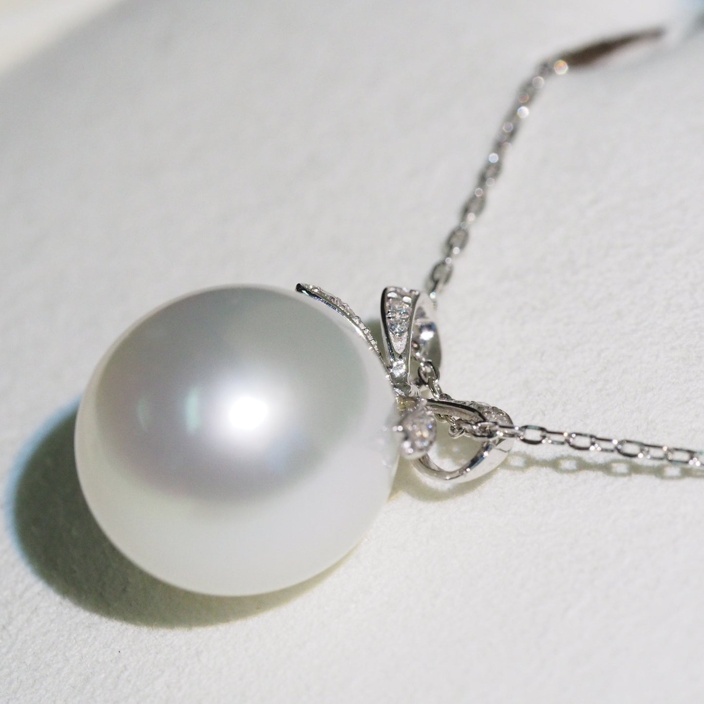 South Sea pearl pendant side view — diamond bow platinum design | Tayam Sydney CBD