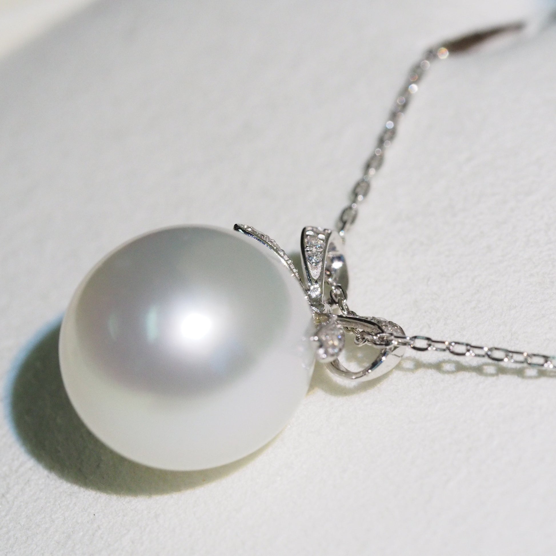 South Sea pearl pendant side view — diamond bow platinum design | Tayam Sydney CBD