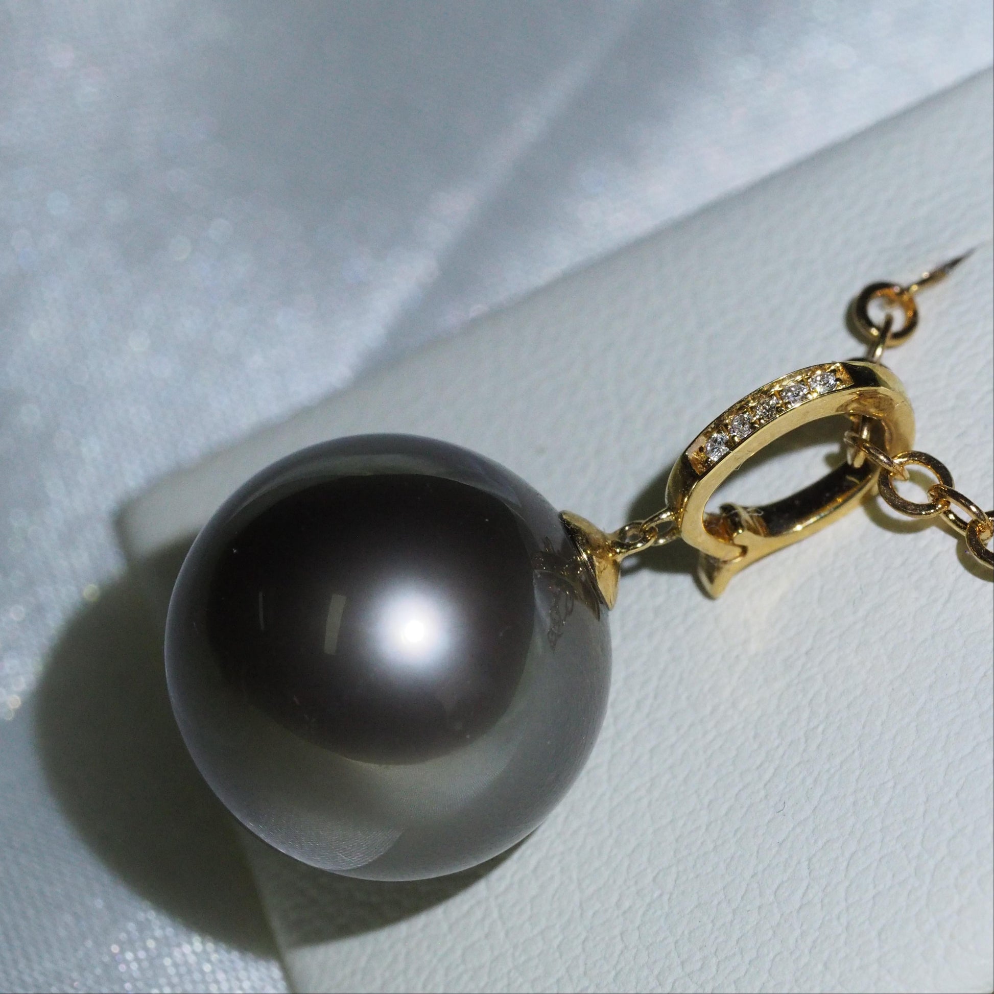 Tahitian pearl pendant close-up — face clean black pearl diamond bail 18K gold | Tayam Jewellery Sydney